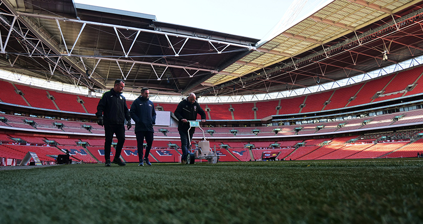 Volunteer groundskeepers help get Wembley pitch match fit